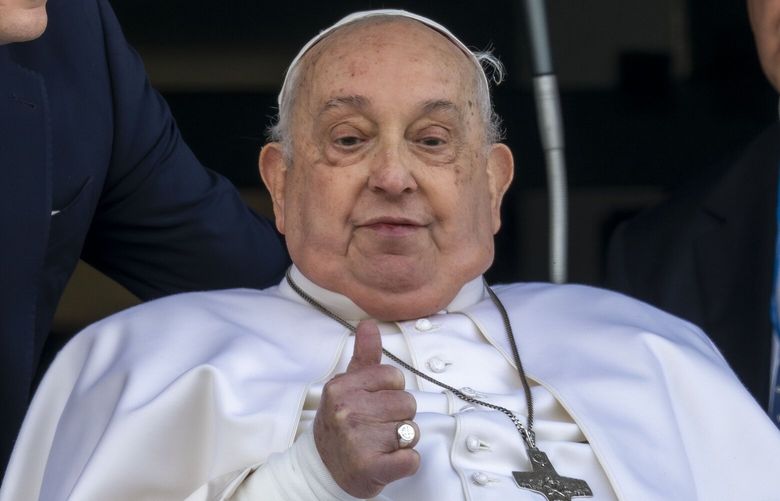 Pope Francis appears at a window of the Agostino Gemelli Polyclinic in Rome, Sunday, March 23, 2025, where he has been treated for bronchitis and bilateral pneumonia since Feb. 14. (AP Photo/Domenico Stinellis) XDS116 XDS116