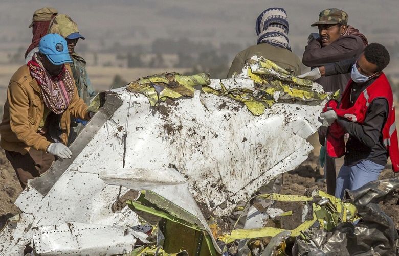 Rescuers work at the scene of an Ethiopian Airlines flight crash near Bishoftu, or Debre Zeit, south of Addis Ababa,  Ethiopia, Monday, March 11, 2019. A spokesman says Ethiopian Airlines has grounded all its Boeing 737 Max 8 aircraft as a safety precaution, following the crash of one of its planes in which 157 people were killed. (AP Photo/Mulugeta Ayene)