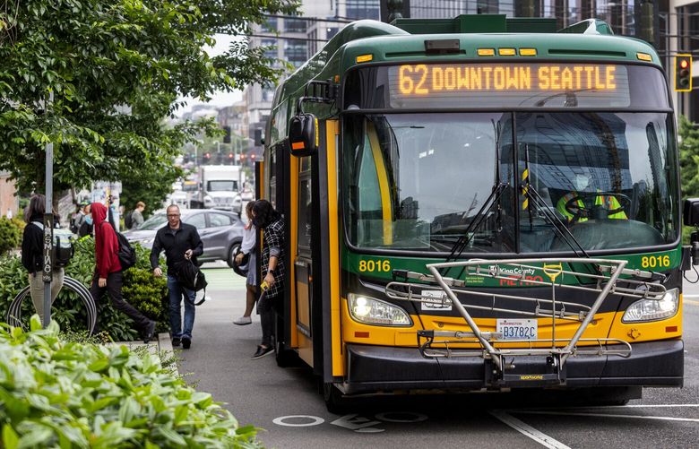 Morning commuters get off the 62 bus in South Lake Union, Tuesday, June 13, 2023 in Seattle. May saw a notable bump in Metro ridership with Amazon’s back-to-the-office order.