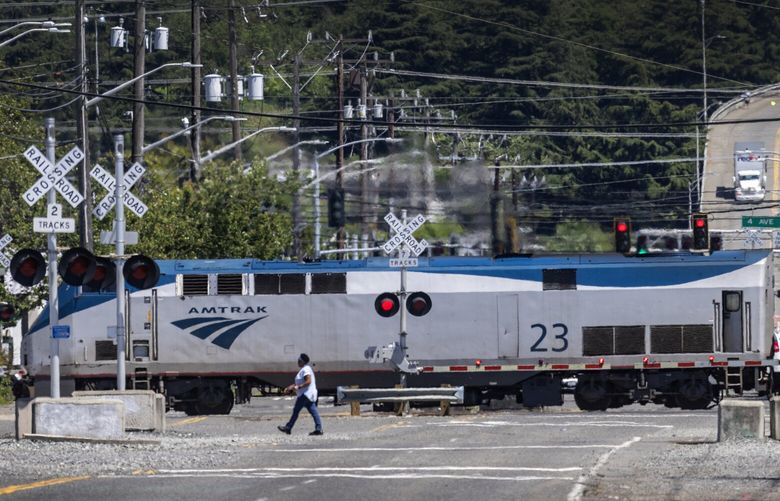 The Amtrak Cascades train stops traffic along South Holgate Street, where the passenger railway harbors big plans to increase passenger trips between Seattle and Portland.