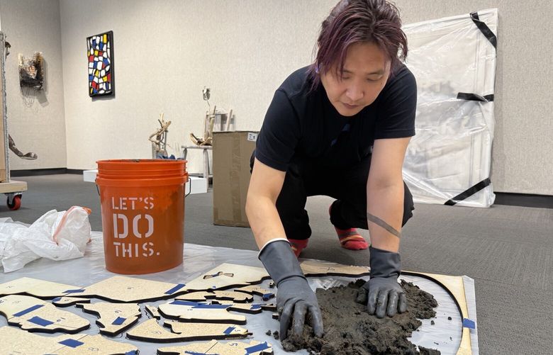 Under the motto “make art, not landfill,” the trash-collecting company Recology has offered a four-month artist residency to local artists. A new show groups together program alumni’s new work. Shown here is artist Philippe Hyojung Kim working on a large-scale floor piece made from ground moss and soil sourced from Duwamish River during low-tide plus laser-cut MDF.