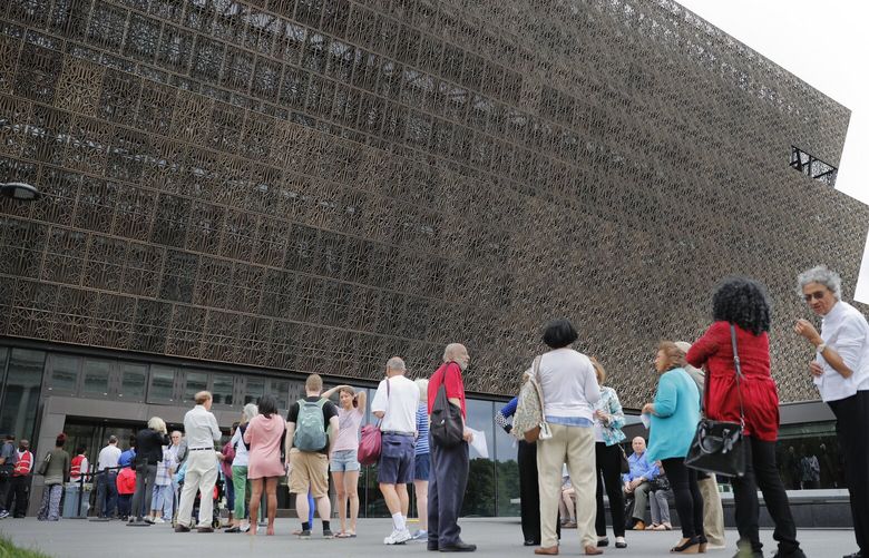 FILE- People wait in line to enter the Smithsonian National Museum of African American History and Cultural on the National Mall in Washington, Mat 1, 2017. (AP Photo/Pablo Martinez Monsivais, File) WX112 WX112