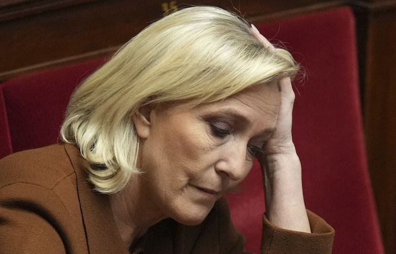 FILE – French far-right leader Marine Le Pen reacts at the National Assembly before French Prime Minister Francois Bayrou delivers his general policy speech meant to outline his top priorities, Tuesday, Jan. 14, 2025 in Paris. (AP Photo/Thibault Camus, File) SOB109 SOB109