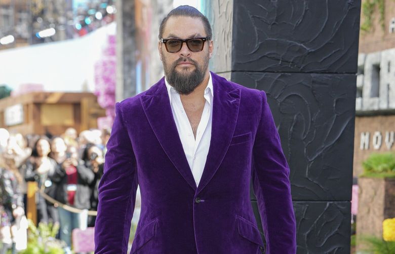 Jason Momoa pose for photographers upon arrival at the World premiere of A Minecraft Movie, March 30, 2025, in London.