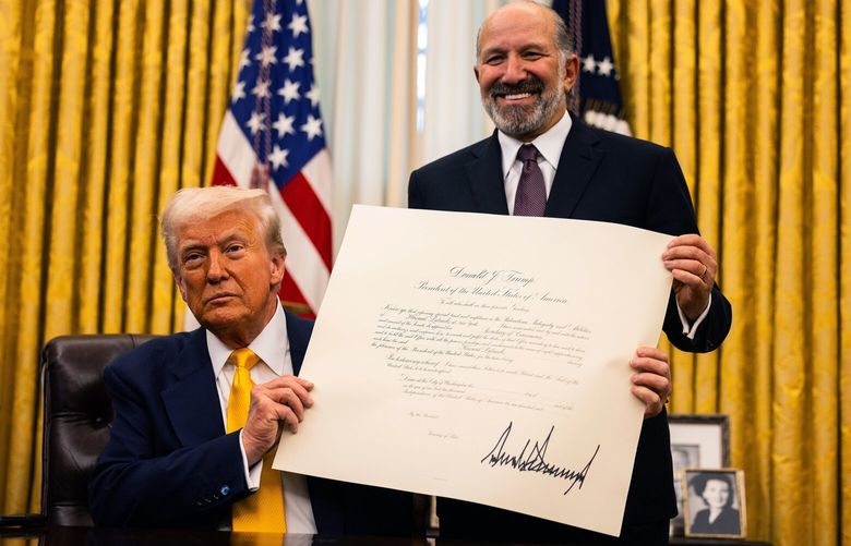 President Donald Trump holds the commission with Commerce Secretary Howard Lutnick after signing it during a ceremony in the Oval Office of the White House in Washington, on Friday, Feb. 21, 2025. More than 800 people at the Weather Service and its parent agency, the National Oceanic and Atmospheric Administration were expected to lose their jobs, the latest cuts in the Trump administration’s sweeping efforts to reshape the federal work force.  (Tierney L. Cross/The New York Times) XNYT0031 XNYT0031