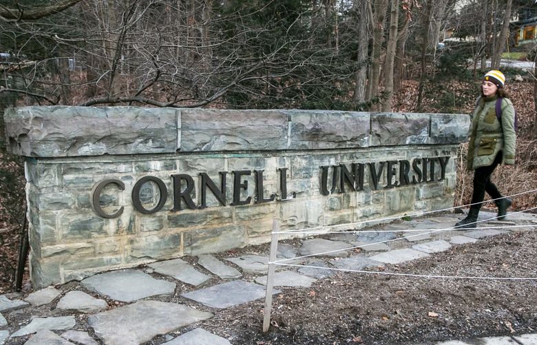 A woman walks by a Cornell University sign on the Ivy League school’s campus in Ithaca, New York, on Friday, Jan. 14, 2022.   (AP Photo/Ted Shaffrey, File) NY107 NY107