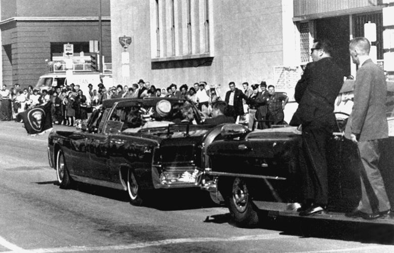 FILE – Secret servicemen standing on running boards follow the presidential limousine carrying President John F. Kennedy, right, rear seat, and first lady Jacqueline Kennedy, left, as well as Texas Gov. John Connally and his wife, Nellie, in Dallas, Texas, Nov. 22, 1963.   (AP Photo/Jim Altgens, File) NY115 NY115