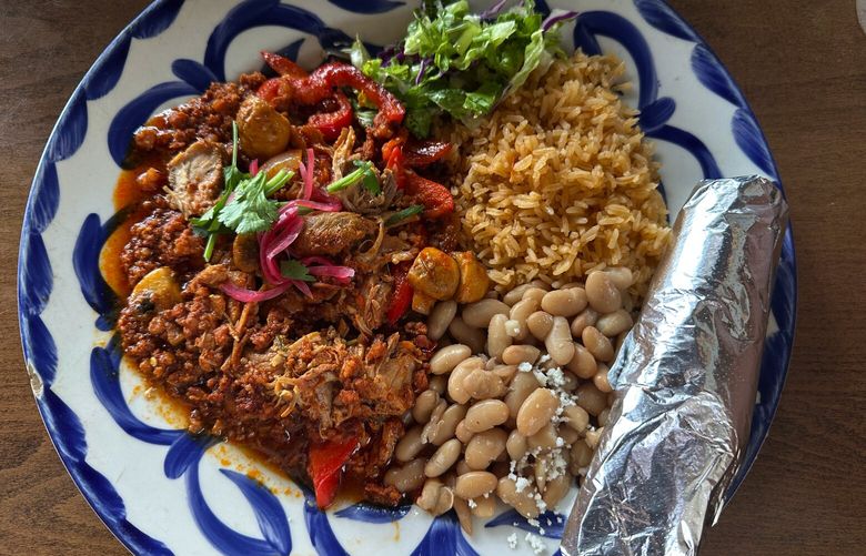 The El Conquistador at La Conner’s COA Mexican Eatery is a platter overflowing with succulent pork, chorizo, rice and beans.
