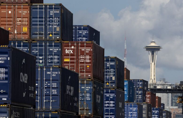 The Space Needle is seen beyond hundreds of shipping containers stacked on Harbor Island on Wednesday, March 5, 2025, in Seattle.