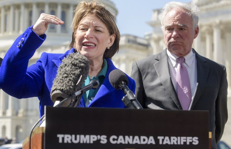 Sen. Tim Kaine, D-Va., right, listens as Sen. Amy Klobuchar, D-Minn., speaks during a news conference regarding President Donald Trump’s pending tariffs on Canada, at the Capitol, Tuesday, April 1, 2025, in Washington. (AP Photo/Rod Lamkey, Jr.) DCRL133 DCRL133