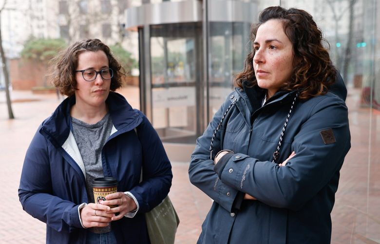 Rachel Gittleman, left, and Stephanie Sampedro, both program analysts with the U.S. Department of Education office of Federal Student Aid outside the Henry M. Jackson Federal Building in Seattle on Wednesday, April 2, 2025. Gittleman and other employees are losing their jobs in Trump administration and DOGE cutbacks.