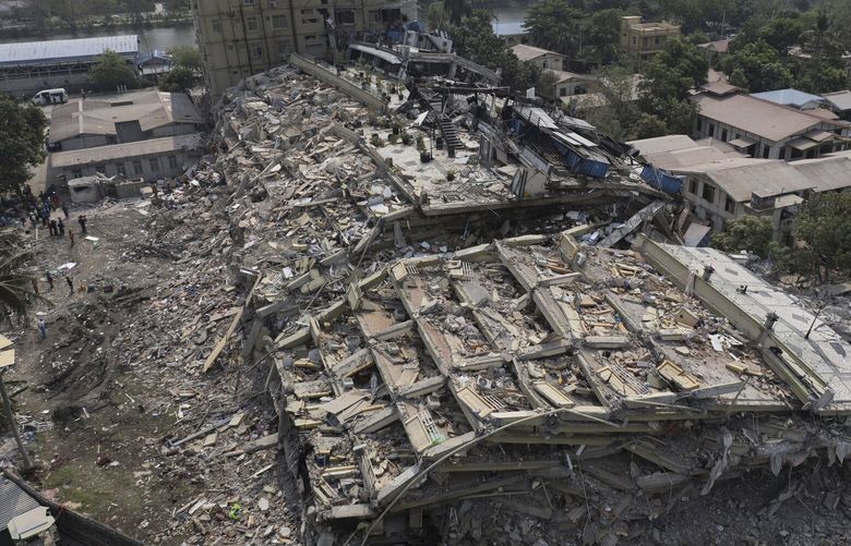 In this photo released by Xinhua News Agency, rescuers conduct searches for survivors at the collapsed Sky Villa residence in Mandalay, Myanmar,  Tuesday, April 1, 2025. (Cai Yang/Xinhua via AP) XIN802 XIN802