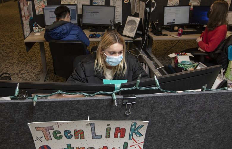 At the Crisis Connections offices, 17-year-old Laney Brackett helps another teen via text messaging through the Teen Link hotline, where young people navigate crisis and mental health concerns, Wednesday, Feb. 2, 2022 in Renton. 219480