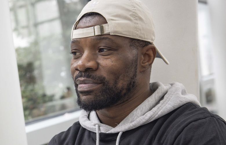 Bruce Batuli Daniel, who is a member of SEIU Local 6, poses for a picture at the Seattle-Tacoma International Airport in SeaTac on Friday, March 28, 2025.  229662