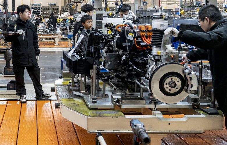 Workers at a factory of the electric carmaker Zeekr in Ningbo, China, March 31, 2025. When Zeek opened its factory in Ningbo four years ago, the facility had 500 robots. Now it has 820, with more on the way. (Qilai Shen/The New York Times)