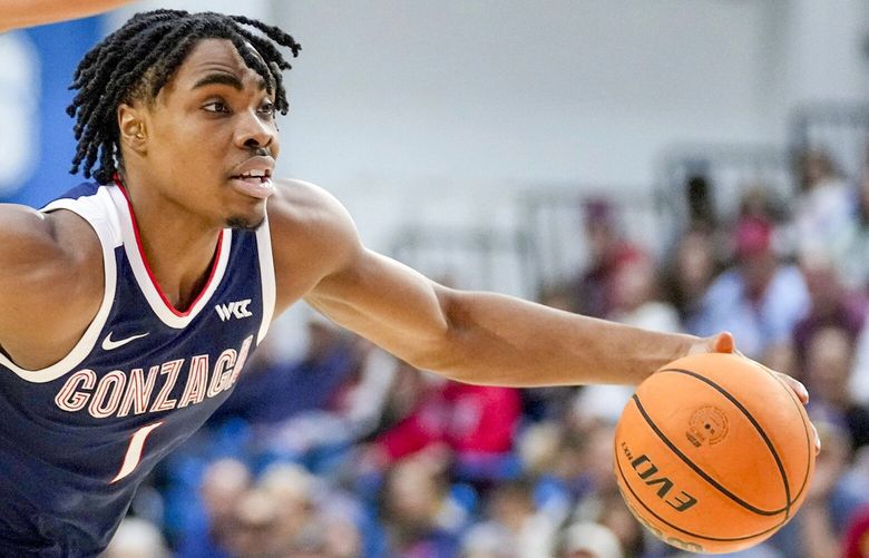 Gonzaga guard Michael Ajayi dribbles against Loyola Marymount forward Jevon Porter during an NCAA college basketball game, Jan. 4, 2025, in Los Angeles.