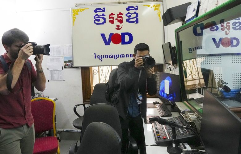 Journalists photograph the newsroom for the Voice of Democracy, VOD, Feb. 13, 2023, in Phnom Penh, Cambodia. Cambodia’s Prime Minister Hun Sen announced, Feb. 12, the independent media broadcaster to shut down for publishing an article he said intentionally slandered his son in connection with the country’s relief assistance to earthquake victims in Turkey.
