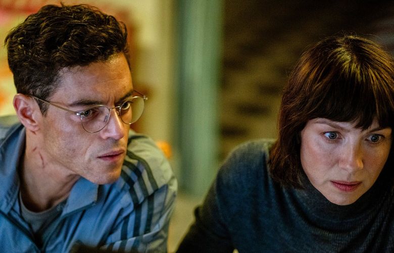 Rami Malek, left, and Caitriona Balfe in a scene from “The Amateur.” (John Wilson / 20th Century Studios / TNS)