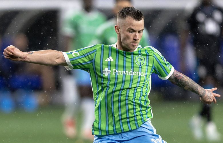 Seattle Sounders midfielder Albert Rusnák shoots against Charlotte FC defender Nathan Byrne during an MLS soccer match, Feb. 22, 2025, in Seattle.