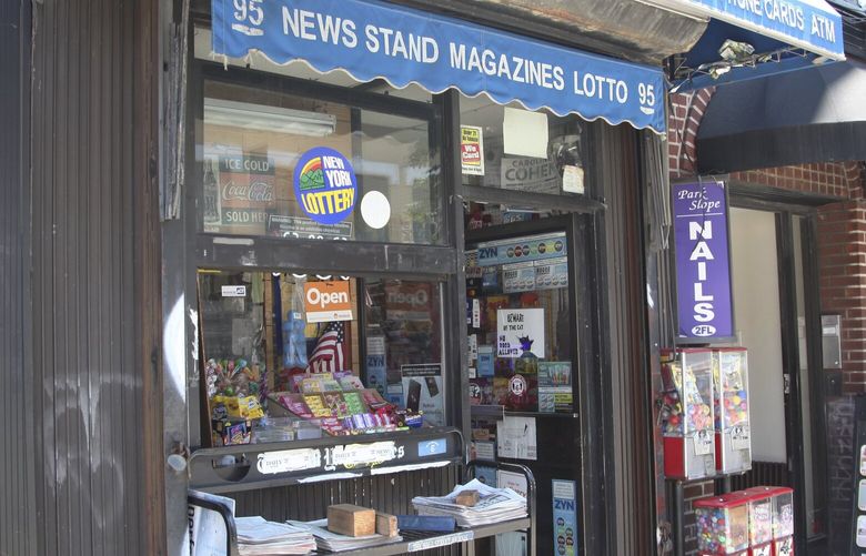 Various local newspapers appear outside a convenience store, June 30, 2022, in the Brooklyn borough of New York. The United States continues to see newspapers die at the rate of two per week, according to a report issued Wednesday on the state of local news. The country had 6,377 newspapers at the end of May, down from 8,891 in 2005, the report said.