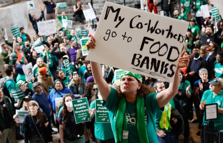 Marie Buss from Tacoma joins others in the rotunda of the state Capitol building during a rally held by WFSE Local 443 in Olympia on Wednesday, April 9, 2025. They were there to protest proposed budget cuts that could result in furloughs and changes for state workers’ benefits. 229752