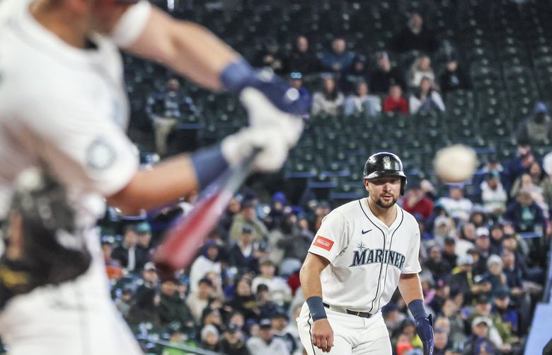 Seattle Mariners designated hitter Cal Raleigh on the line awaiting Seattle Mariners catcher Mitch Garver at bat early Wednesday afternoon at T-Mobile Park in Seattle, Washington, on April 2, 2025. The Mariners won 3-2. 229562