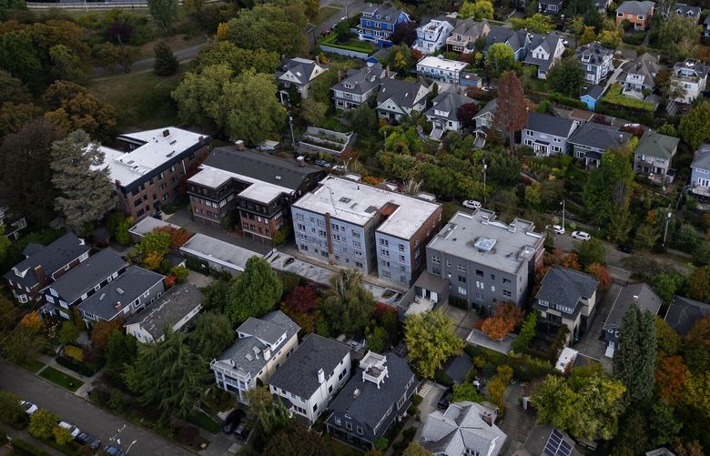 Capitol Hill single family homes and apartments are seen from the air, Wednesday, Oct. 2, 2024 in Seattle. At upper left is the Volunteer Park reservoir and water tower. Lake Washington and the SR-520 floating bridge are off in the distance.