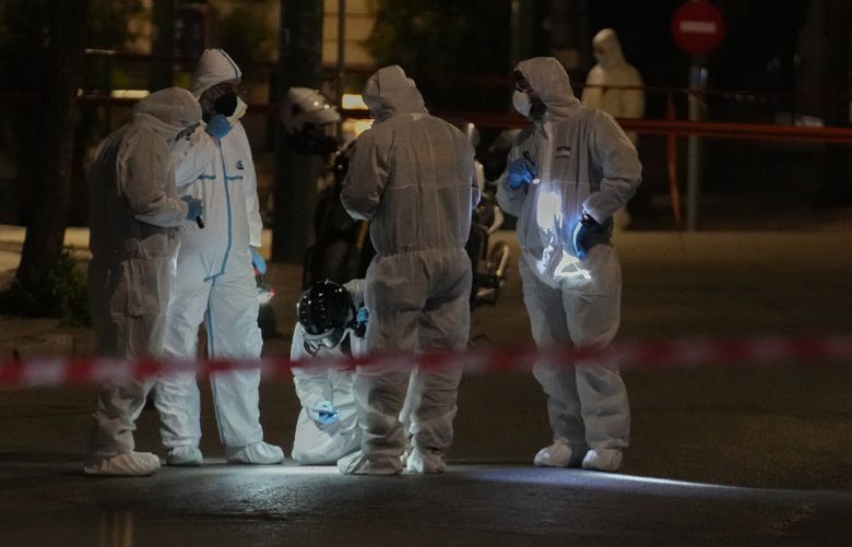 Police officers from the forensics department check the area after a bomb explosion outside of the Hellenic Train offices the company that runs Greece’s railway, in Athens, Greece, Friday, April 11, 2025. (AP Photo/Petros Giannakouris) XPG102 XPG102