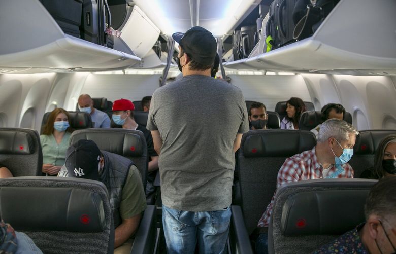 People board a Boeing 737 MAX plane operated by Air Canada at Edmonton International Airport in Alberta, Canada, on Wednesday, July 27, 2022.