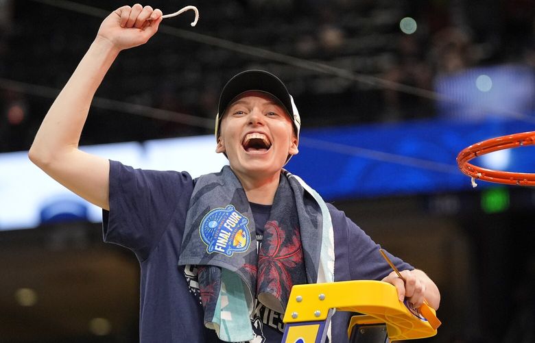 UConn guard Paige Bueckers holds up a piece of the net after the Huskies defeated South Carolina inthe national championship game at the Final Four of the women’s NCAA college basketball tournament, Sunday, April 6, 2025, in Tampa, Fla. (AP Photo/John Raoux) NYJJ764 NYJJ764