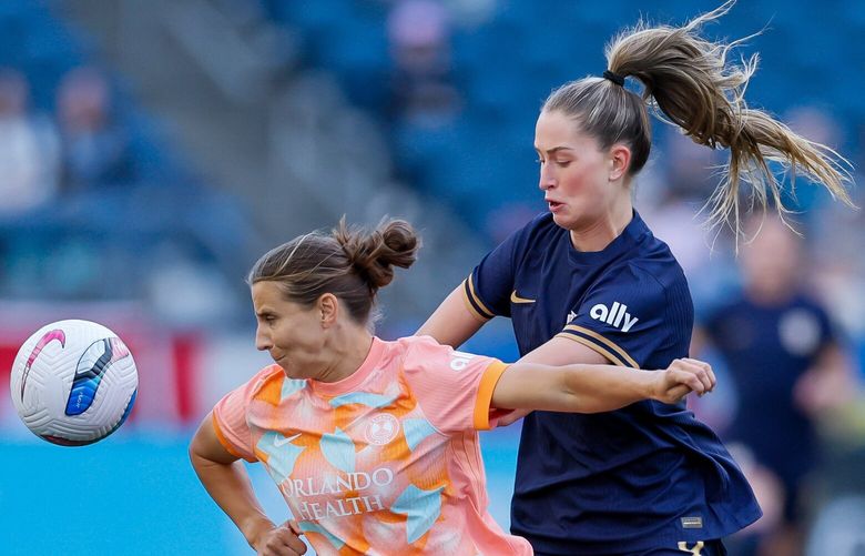 Orlando Pride defender Kylie Nadaner vies for a ball with Seattle Reign FC forward Jordyn Huitema during the first half Saturday, April 12, 2025 in Seattle. 229713
