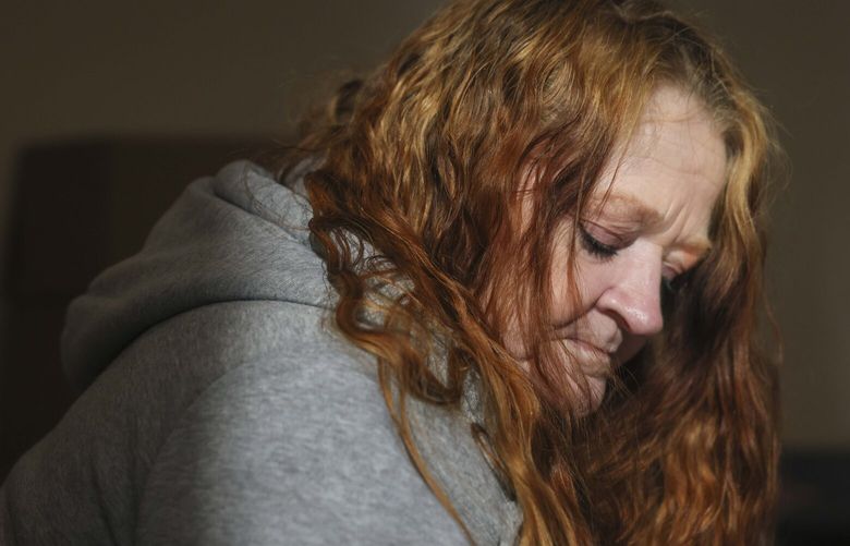Gina pauses after being treated with a monthly medicated buprenorphine injection at the supportive housing building where she resides in Seattle on Wednesday, March 5, 2025. 

 229478