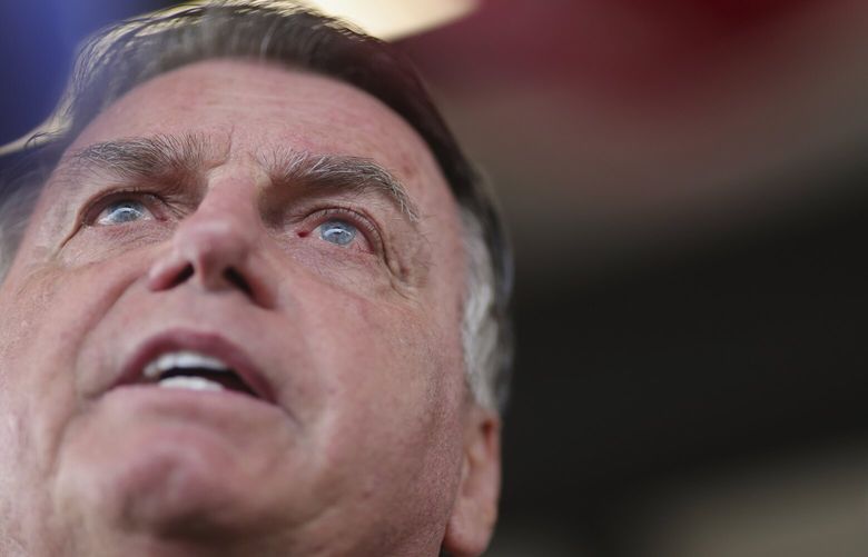FILE – Brazil’s former President Jair Bolsonaro speaks to the media as he arrives at the Brasilia International Airport in Brasilia, Brazil, March 25, 2025. (AP Photo/Luis Nova, File) xlm501 xlm501