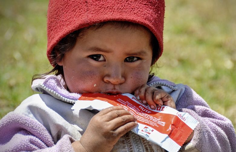 This photo provided by Navyn Salem shows a young child in Guatemala on March 14, 2016, eating Plumpy’Nut, a nutritional lifesaving peanut paste produced by Salem’s company Edesia Nutrition and sent to malnourished children worldwide. (Navyn Salem via AP) RIDG207 RIDG207