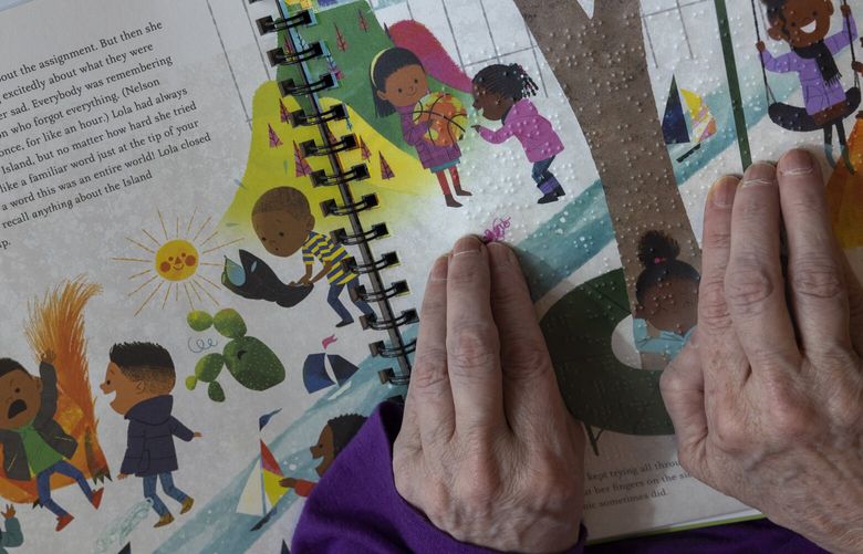 Marci Carpenter, of West Seattle, reads braille in a children’s book at the Washington Talking Book & Braille Library (WTBBL). She often takes books to schools and reads books to students — they can follow along with the same words in the book, on the opposite page.
The WTBBL is just one cultural organization reeling from the Trump administration’s cuts of public funding to libraries and other institutions. Immediately at risk are blind readers in Washington, California and Connecticut, so far, where funding has been cut, and elsewhere.
The library, which has around 200 volunteers, is located at 2021 Ninth Avenue in Seattle, shot Thursday, April 10, 2025. 229754