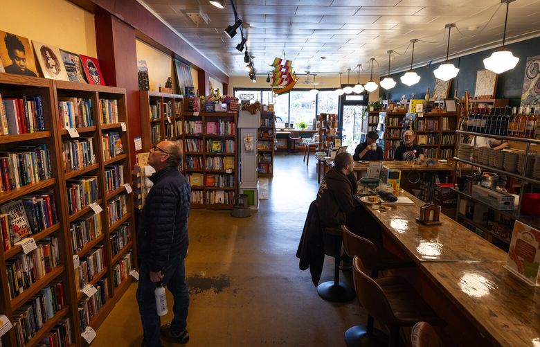 Len Seligman, left, shops at The Couth Buzzard, Wednesday, April 9, 2025, in Seattle’s Greenwood neighborhood. “I just love used bookstores,” said Seligman during his first-time visit.