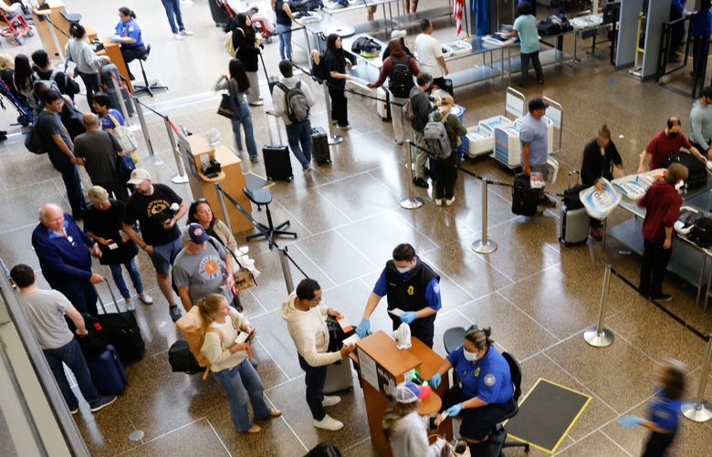Passengers go through TSA security checkpoints at Seattle-Tacoma International Airport in SeaTac on Labor Day, Monday, September 2, 2024. Crowds were typical.