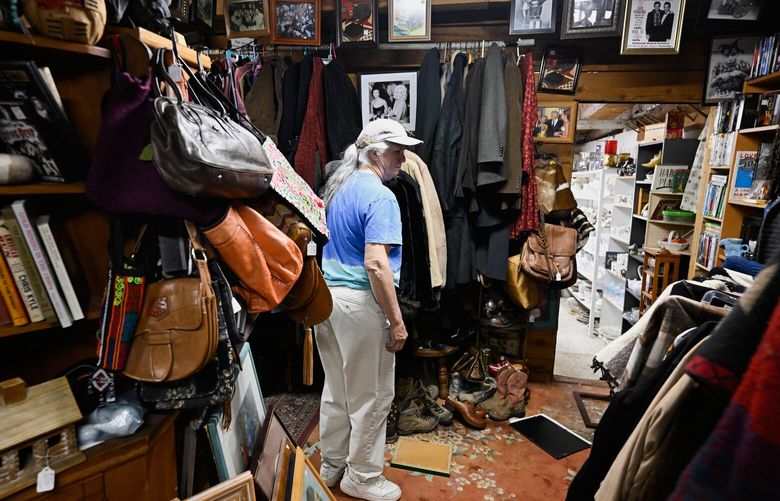 Tracy Turner, owner of the Wynola Junction, looks over pictures that fell from shelves when a earthquake hit Monday, April 14, 2025, in Julian, Calif. (AP Photo/Denis Poroy) CADP101 CADP101