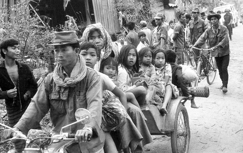 Cambodian women and children fill the back of a motorcycle taxi carrying them to safer parts of Phnom Penh as Khmer Rouge insurgents continued their artillery shellings of the capital on Jan. 28, 1974. (The Associated Press)