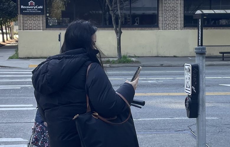 A crosswalk push button at the corner of Denny Way and Fairview Avenue emits what appeared to be an AI-generated voice of Jeff Bezos.