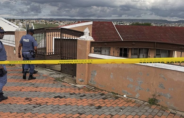 In this photo provided by the South African Police Service, South African law enforcement officers enter the gate of the house where an American missionary Josh Sullivan was being held in KwaMagxaki, Gqeberha, South Africa, Wednesday, April 16, 2025. (South African Police Services via AP) PPE101 PPE101