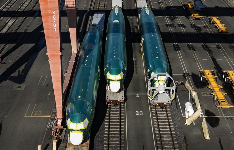 On the eve of Boeing Machinists set to vote on a new proposal to end their strike, a line of 737 Max fuselages heading to Renton are stored on train cars in a rail yard just south of the stadiums in SODO, seen from the air, Tuesday, Oct. 22, 2024 in Seattle. In the background is downtown Seattle.