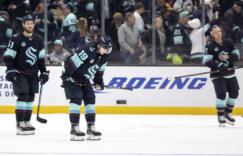 Seattle Kraken left wing Jared McCann (19) and center Shane Wright (51) react after losing 3-2 to the St. Louis Blues in an NHL hockey game on Tuesday, Oct. 8, 2024, in Seattle.