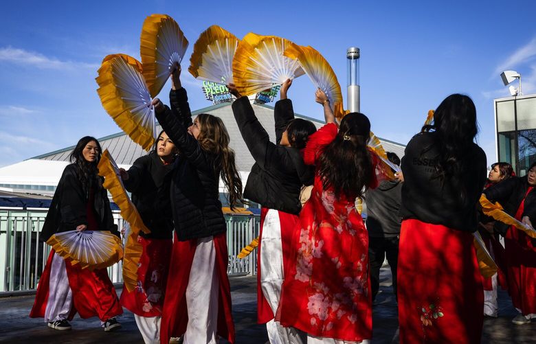 The Lincoln High School Vietnamese Club practice their traditional fan dance routine before performing inside Seattle Center’s Fisher Pavilion for Tet In Seattle celebrations, Sunday, Jan. 26, 2025 in Seattle.