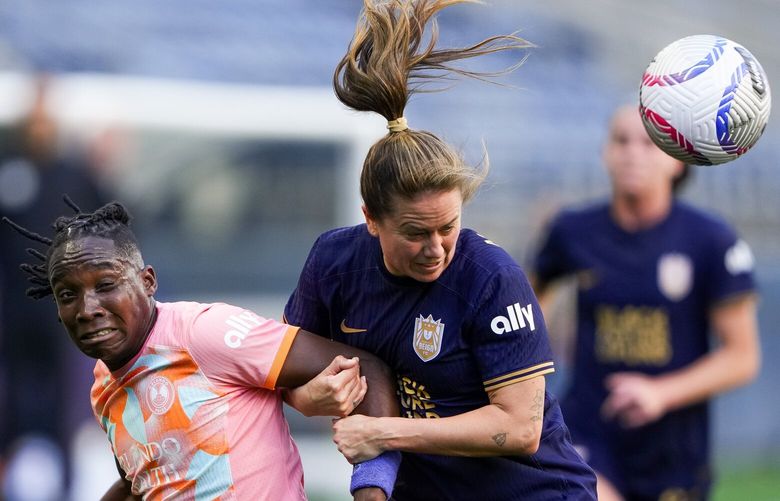 Orlando Pride forward Barbra Banda, left, goes up for the ball against Seattle Reign defender Lauren Barnes (3) during the first half of an NWSL soccer match, Sunday, May 19, 2024, in Seattle. 226948
