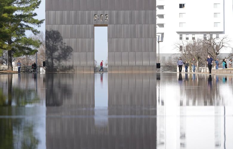 Visitors walk around the Reacting Pond at the Oklahoma City National Memorial & Museum in Oklahoma City on March 12, 2025. (AP Photo/LM Otero) NYRL405 NYRL405