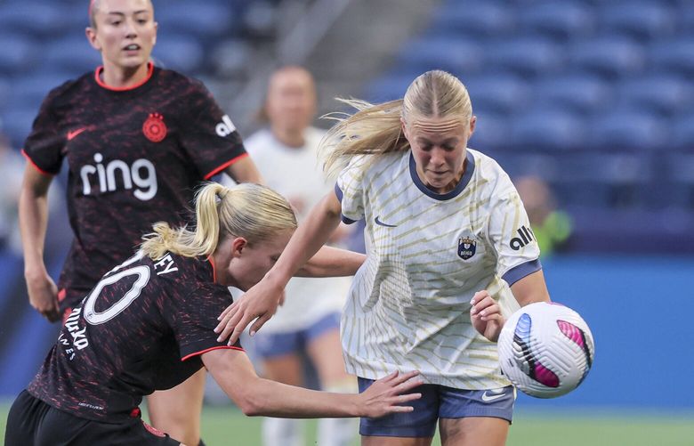 Portland Thorns FC defender Kaitlyn Torpey tracks Seattle Reign forward Maddie Dahlien Friday evening at Lumen Field in Seattle, Washington, on April 18, 2025. The Reign lead 1-0 at the half. 229790