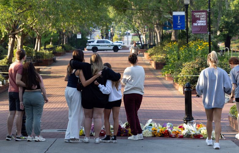 People gather at an impromptu memorial on Florida State University’s campus in Tallahassee, Fla., on Thursday, April 17, 2025, after a 20-year-old student at Florida State University in Tallahassee shot and killed two people on Thursday and injured six, according to police. The gunman was identified as the son of a deputy in the local sheriff’s department, and was taken into custody after being shot by the police, law enforcement officials said. (Erich Martin/The New York Times) XNYT0475 XNYT0475