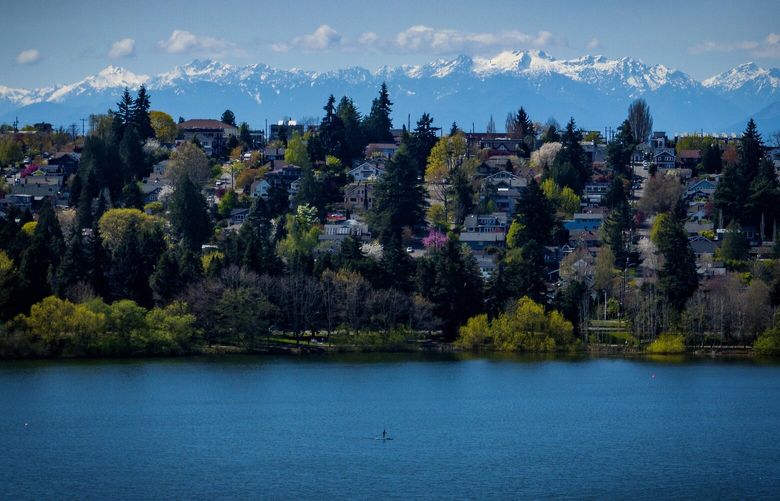 Phinney Ridge separates the Olympic Mountains from Green Lake, as a week of more sun looks to be in the forecast, Sunday, April 13, 2025, in Seattle.