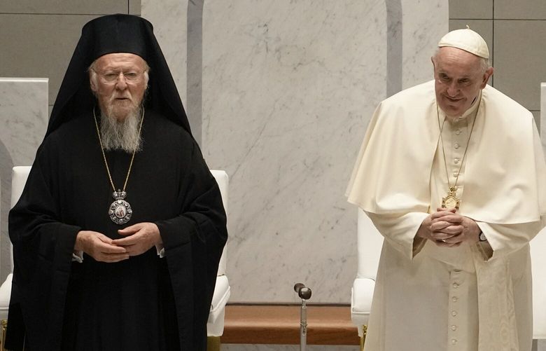 FILE – Pope Francis and Ecumenical Patriarch Bartholomew attend an ecumenical meeting and prayer for peace in Our Lady of Arabia Cathedral, Sakhir, Bahrain, Friday, Nov. 4, 2022. (AP Photo/Alessandra Tarantino, File) AJM163 AJM163